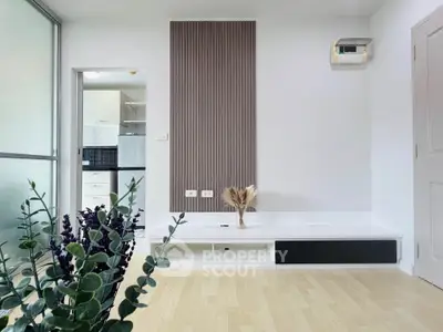 Modern minimalist living room with sleek design and open kitchen view