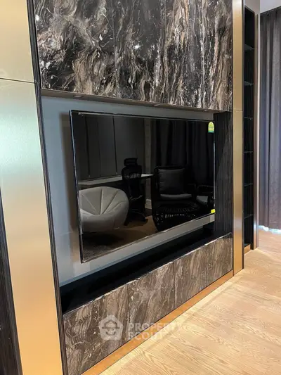 Luxurious modern living room with sleek marble TV wall unit and elegant decor.