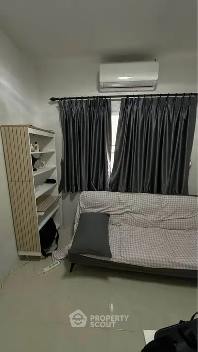 Cozy living room with modern air conditioning and stylish curtains, perfect for relaxation.