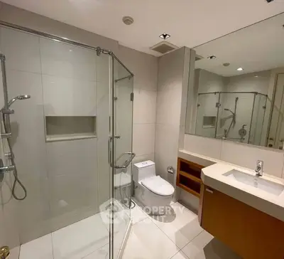 Modern bathroom with glass shower and sleek fixtures