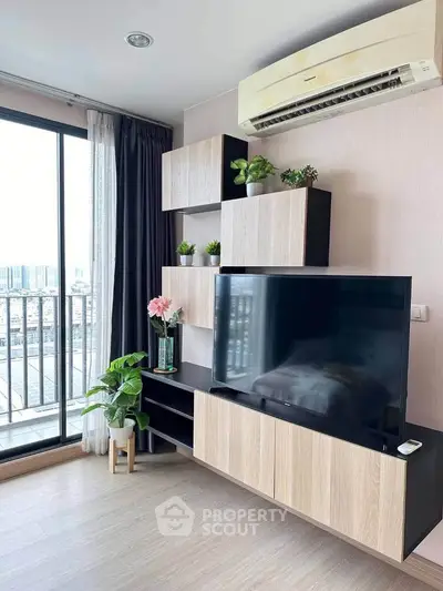 Modern living room with stylish TV unit and balcony view, featuring elegant decor and natural light.
