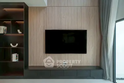 Modern living room with sleek TV setup and elegant shelving