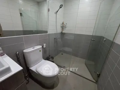 Modern bathroom with glass shower enclosure and sleek fixtures