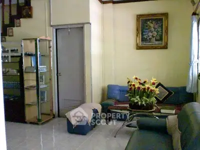Cozy living room with comfortable seating and floral decor, perfect for relaxation and gatherings.