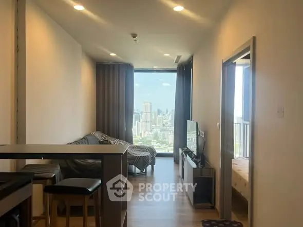 Modern living room with city view, open layout, and stylish furnishings.