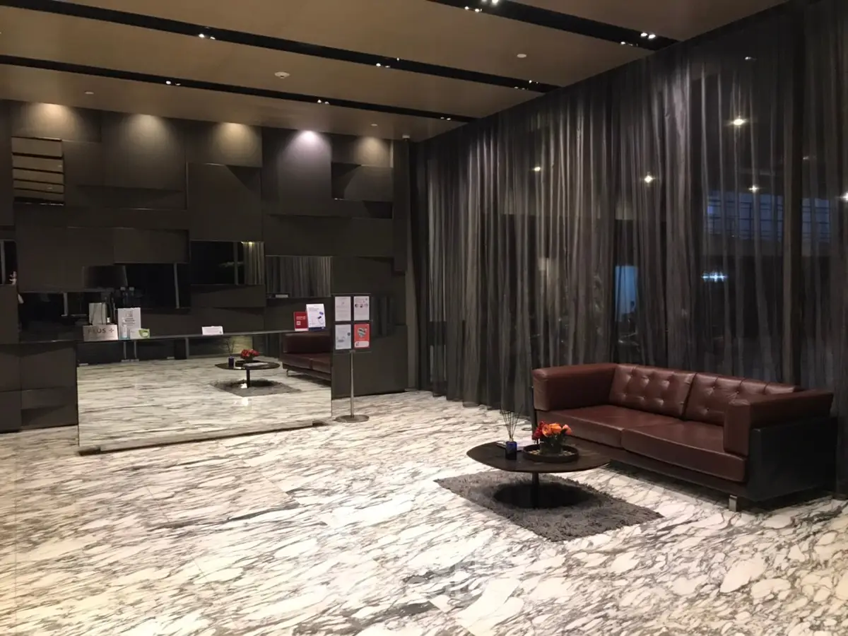 Luxurious modern lobby with marble flooring and elegant seating area.