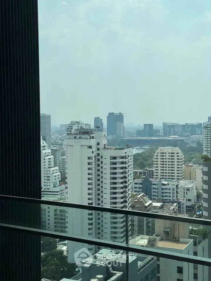 Stunning cityscape view from a high-rise balcony showcasing urban skyline and modern architecture.