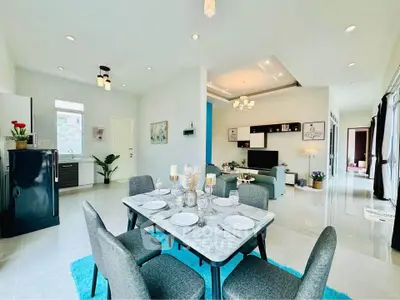 Spacious open-plan living and dining area with modern decor and natural light