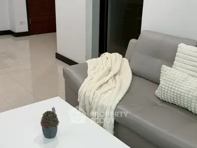 Modern living room with stylish gray sofa and cozy decor