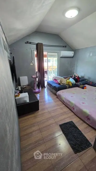 Cozy bedroom with double beds and balcony access in modern home