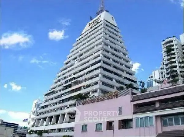 Iconic pyramid-shaped building with unique architectural design against a clear blue sky.