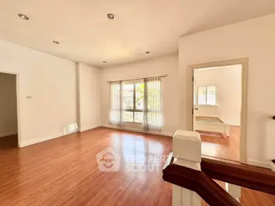 Spacious open living area with wooden flooring and natural light