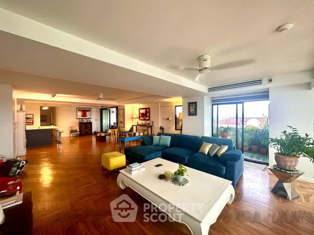 Spacious living room with modern decor and large windows offering natural light.