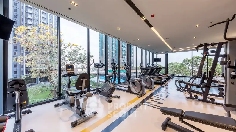Modern gym with state-of-the-art equipment and panoramic city views in luxury residential building.
