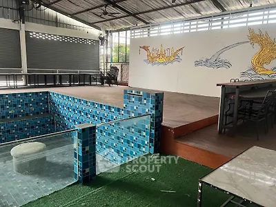 Unique indoor space with tiled pool and artistic wall mural, ideal for creative events.