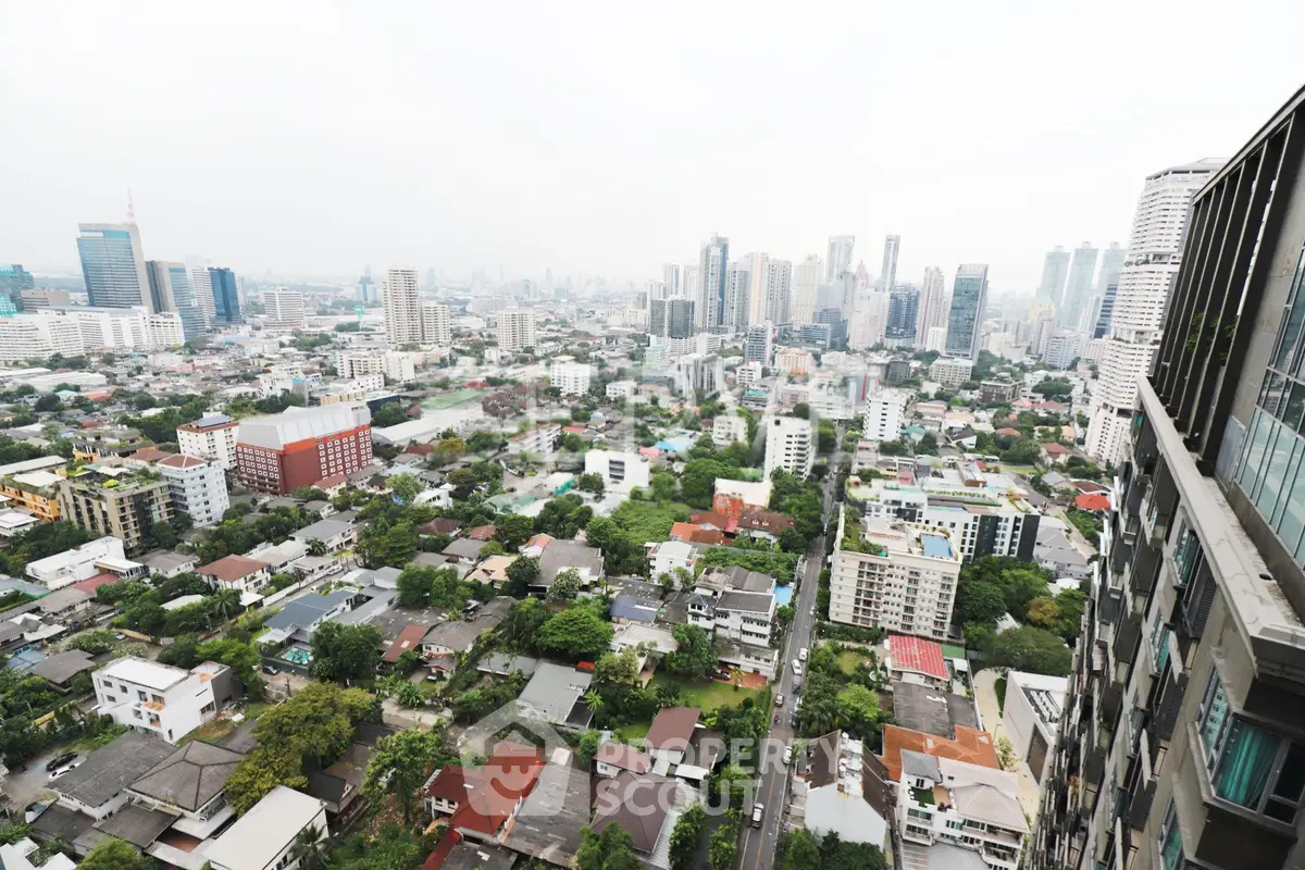 Stunning cityscape view from high-rise building showcasing urban skyline and residential areas.