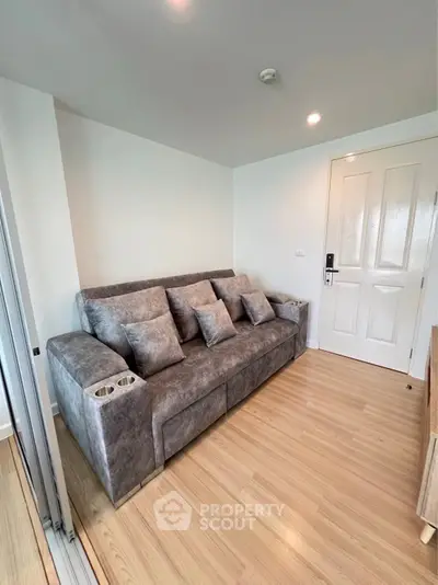 Cozy living room with plush gray sofa and modern decor