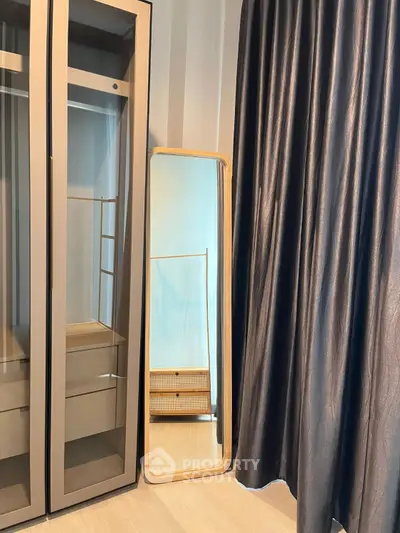Stylish modern wardrobe with full-length mirror and elegant curtains