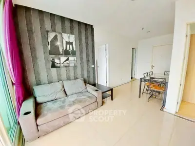 Modern living room with stylish decor and dining area in open layout apartment.