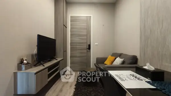 Modern living room with sleek furniture and wall-mounted TV