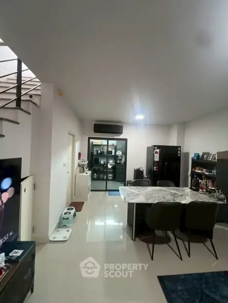 Modern open-plan living area with sleek kitchen and dining space