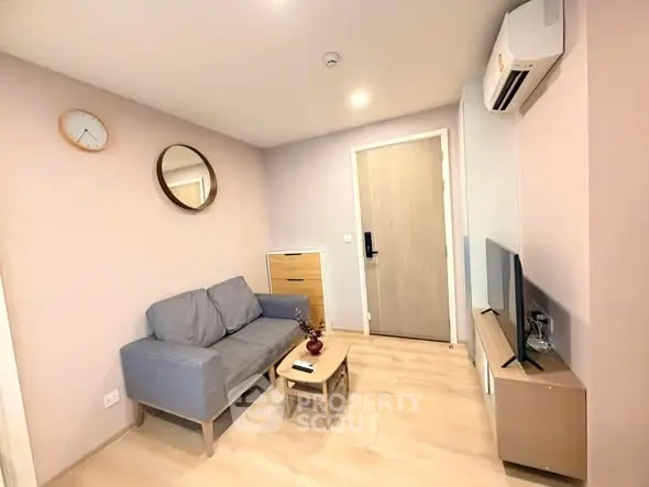 Cozy modern living room with stylish furniture and air conditioning in a contemporary apartment.