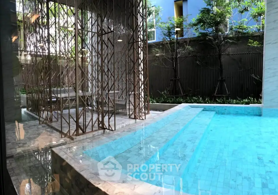 Luxurious modern pool area with elegant design and lush greenery, perfect for relaxation and leisure.