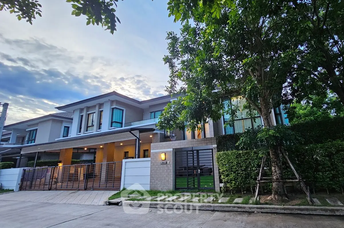 Modern two-story house with lush greenery and spacious driveway