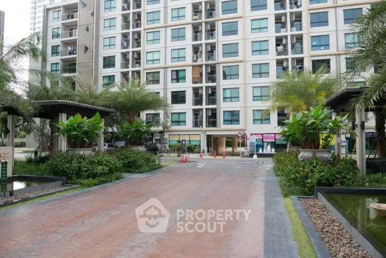 Modern apartment building with lush landscaping and welcoming entrance.