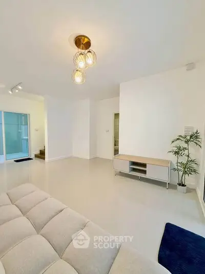 Spacious modern living room with elegant lighting and minimalist decor