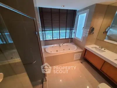 Luxurious bathroom with modern fixtures and large bathtub in elegant apartment.