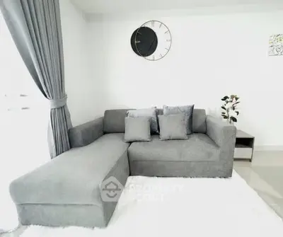 Modern living room with stylish gray sectional sofa and elegant decor