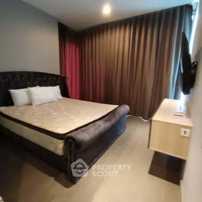 Cozy bedroom with elegant bed and modern decor, perfect for relaxation.