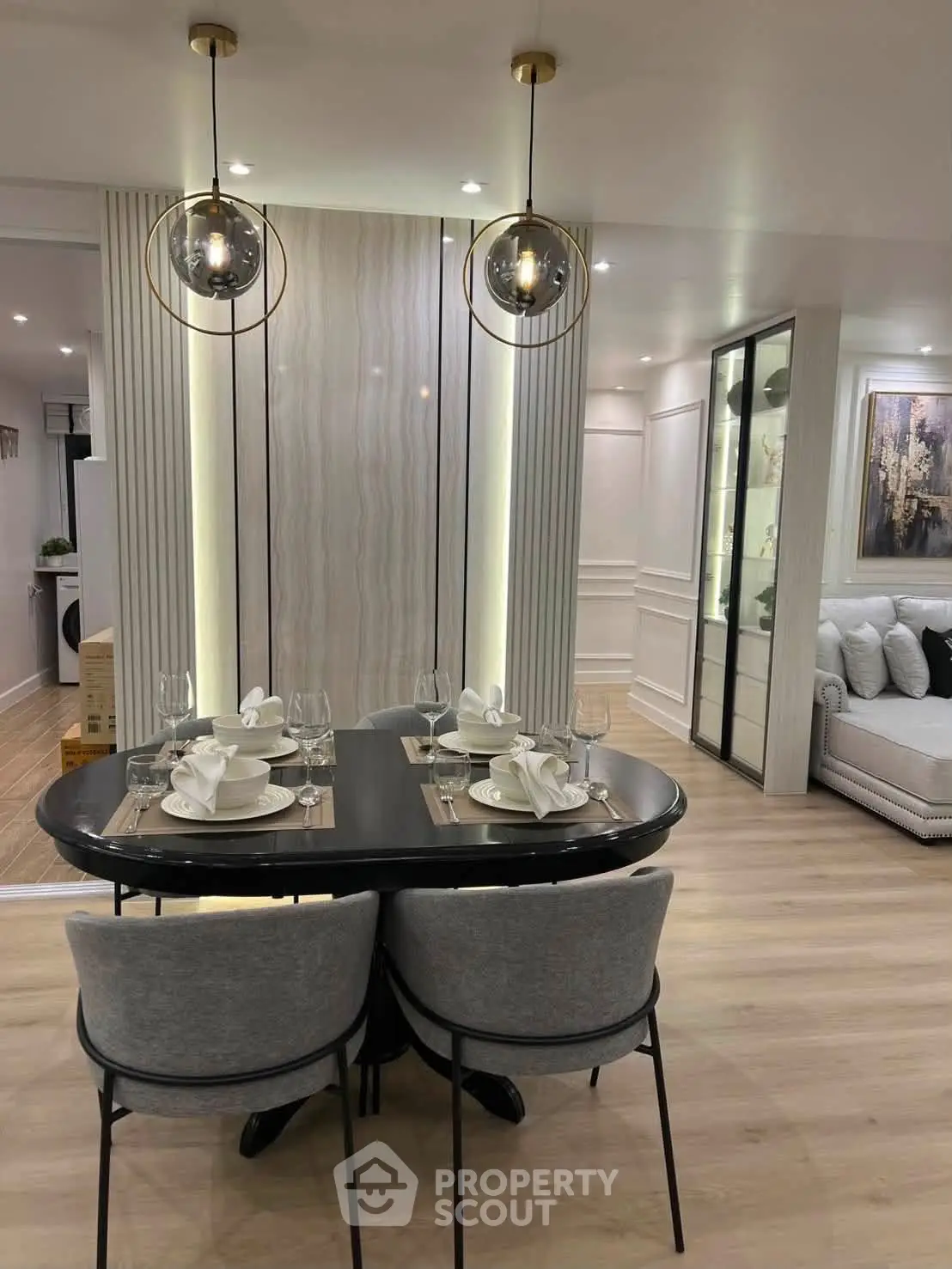 Elegant modern dining area with stylish lighting and luxurious decor in a contemporary apartment.