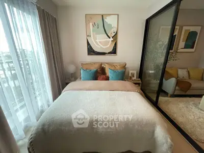 Cozy bedroom with modern decor and large window for natural light