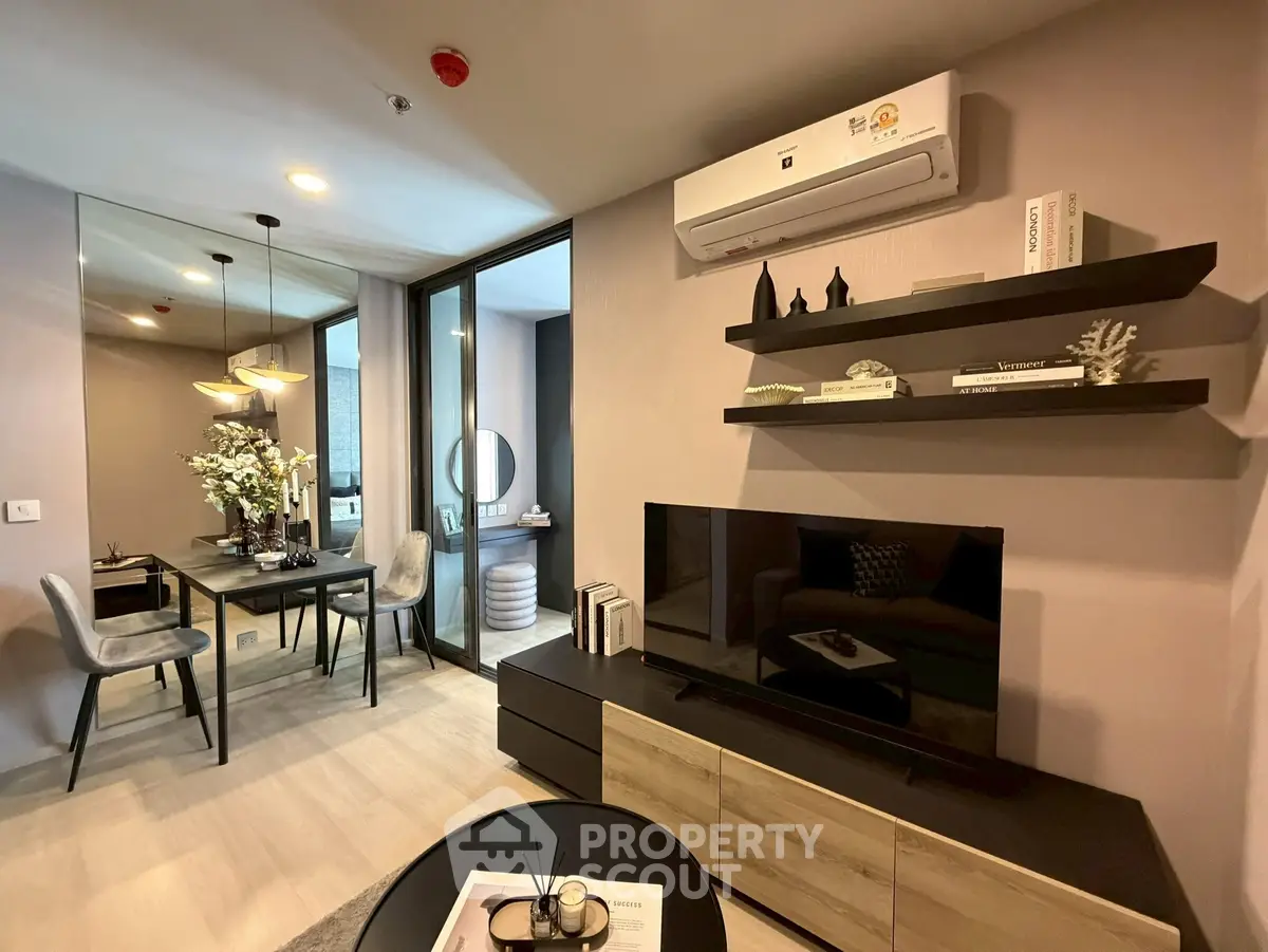 Modern living room with stylish decor and dining area, featuring sleek furniture and ambient lighting.