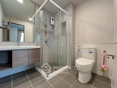 Modern bathroom with glass shower enclosure and sleek fixtures