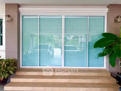 Modern home entrance with large glass sliding doors and elegant steps