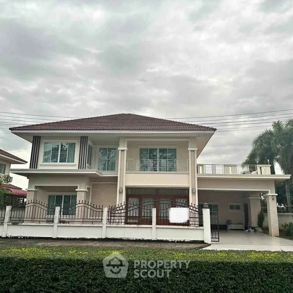 Elegant two-story house with spacious driveway and modern design under cloudy sky.