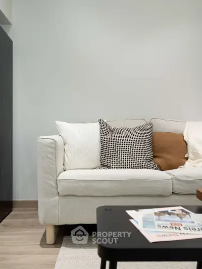 Modern living room with stylish sofa and cozy decor accents.