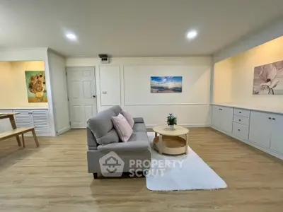 Spacious living room with modern decor and cozy seating area.