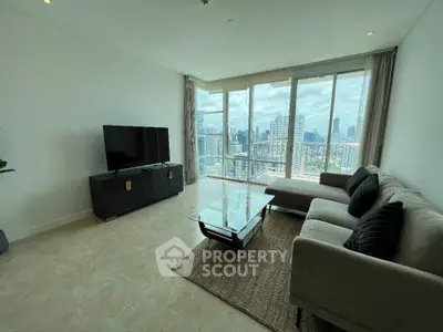 Spacious living room with panoramic city views and modern furnishings