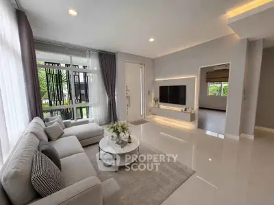 Modern living room with sleek design and large windows for natural light