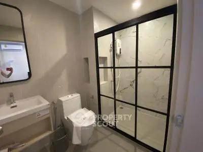 Modern bathroom with sleek shower enclosure and contemporary fixtures.