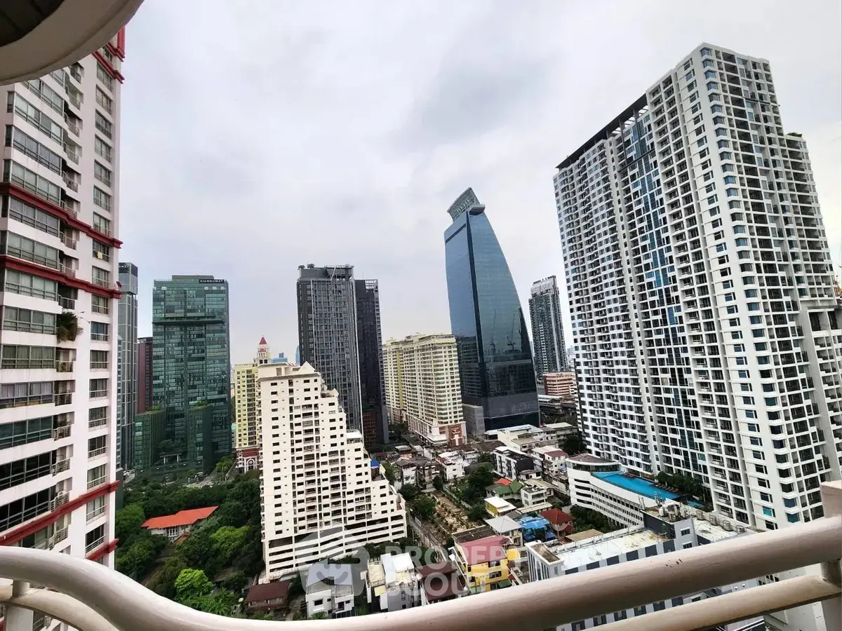 Stunning cityscape view from a high-rise balcony showcasing modern skyscrapers and urban living.
