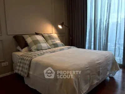 Cozy bedroom with stylish decor and large window offering city view