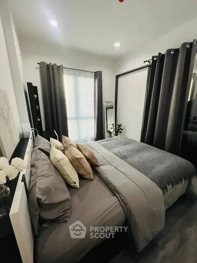 Cozy and modern bedroom with stylish decor and natural light.