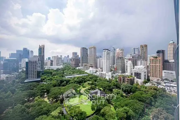 Stunning cityscape view with lush greenery and modern skyscrapers.