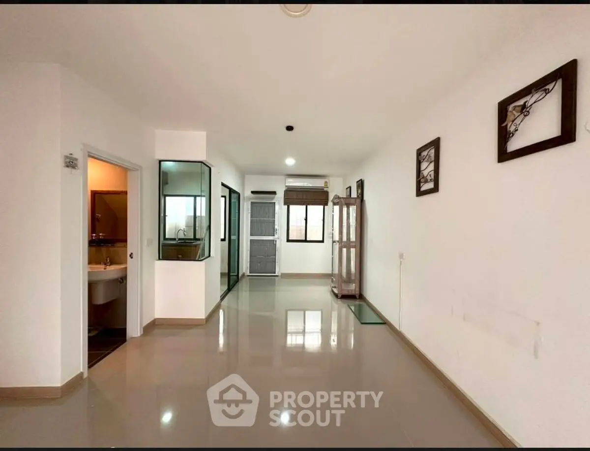 Spacious modern apartment interior with glossy floors and stylish decor, featuring a sleek open layout.