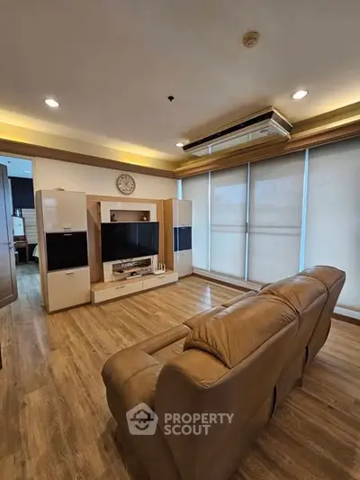 Spacious living room with modern decor and large windows for natural light.